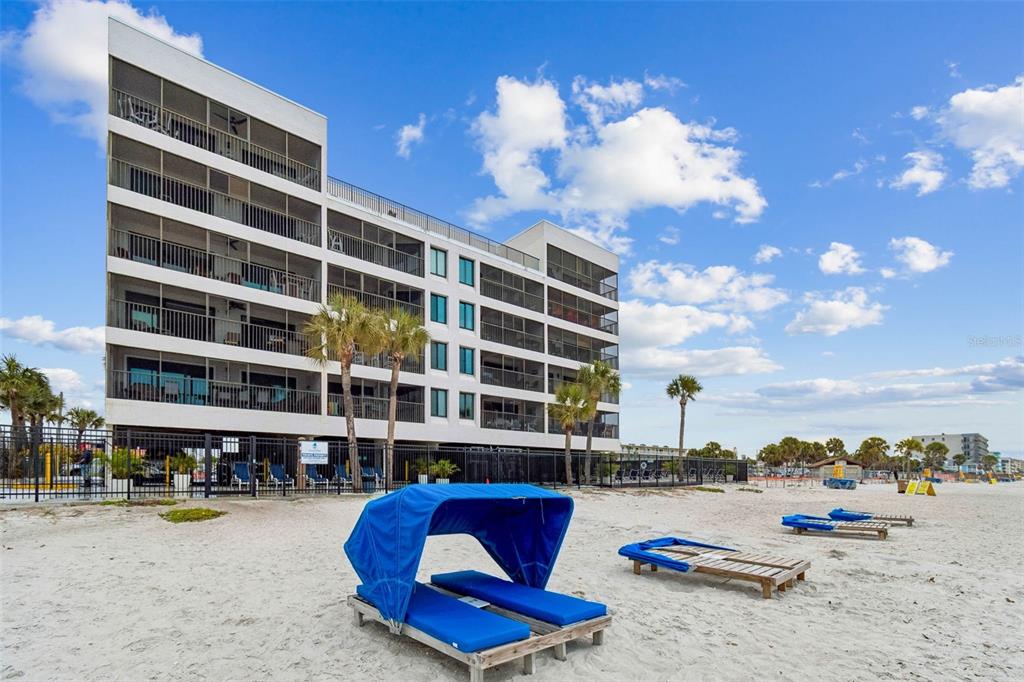14600 Gulf Boulevard, Unit 102 Madeira Beach, FL 33708 - Photo 45 of 46 a view of a swimming pool with a lounge chair and tables