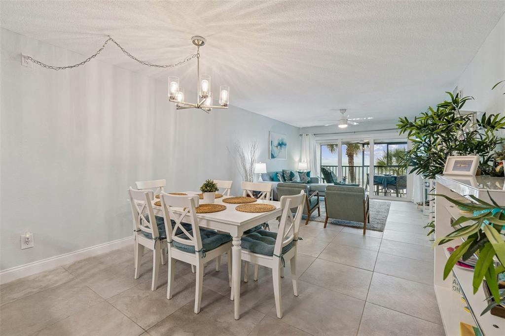 14600 Gulf Boulevard, Unit 102 Madeira Beach, FL 33708 - Photo 6 of 46 a view of a dining room with furniture and chandelier