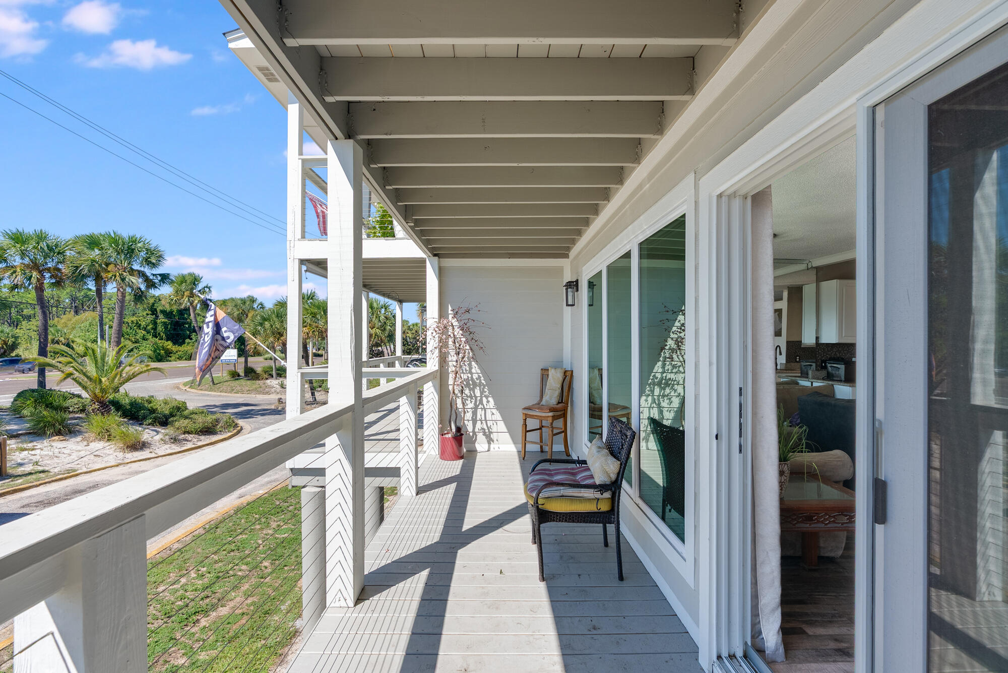 200 Pensacola Beach Road, Unit D2 Gulf Breeze, FL 32561 - Photo 11 of 38 a porch with a table and chairs