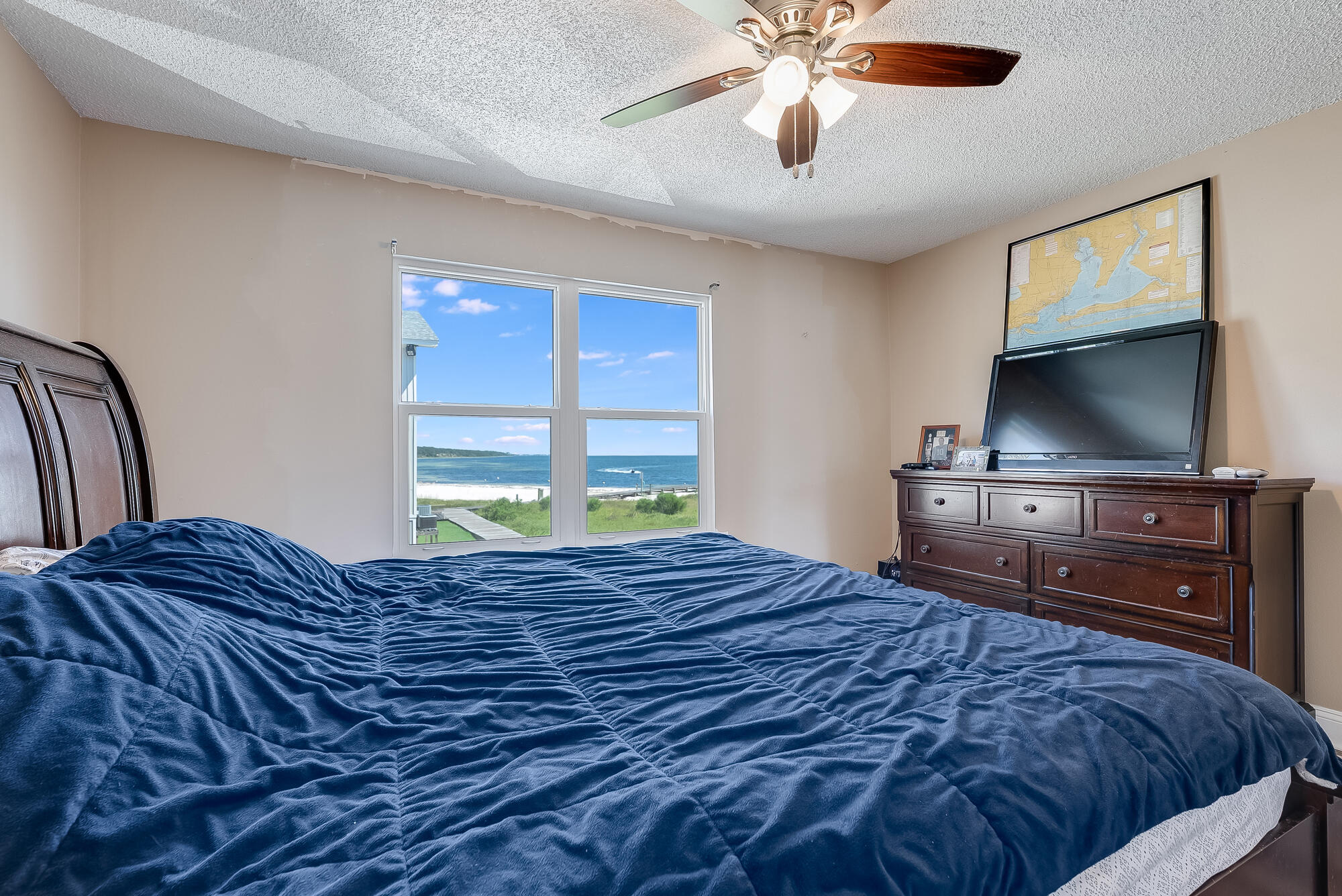 200 Pensacola Beach Road, Unit D2 Gulf Breeze, FL 32561 - Photo 16 of 38 a bedroom with a bed and a flat screen tv
