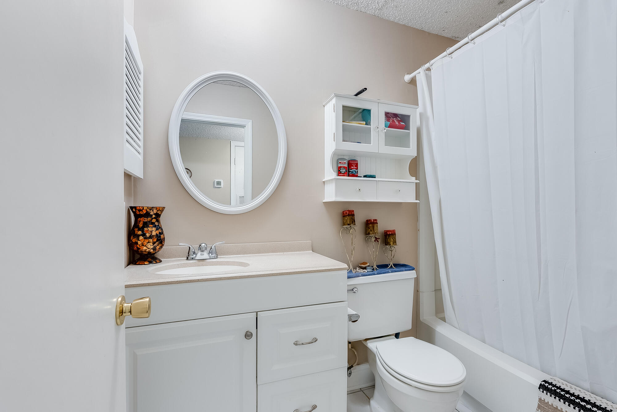 200 Pensacola Beach Road, Unit D2 Gulf Breeze, FL 32561 - Photo 20 of 38 a bathroom with a sink a toilet and a mirror