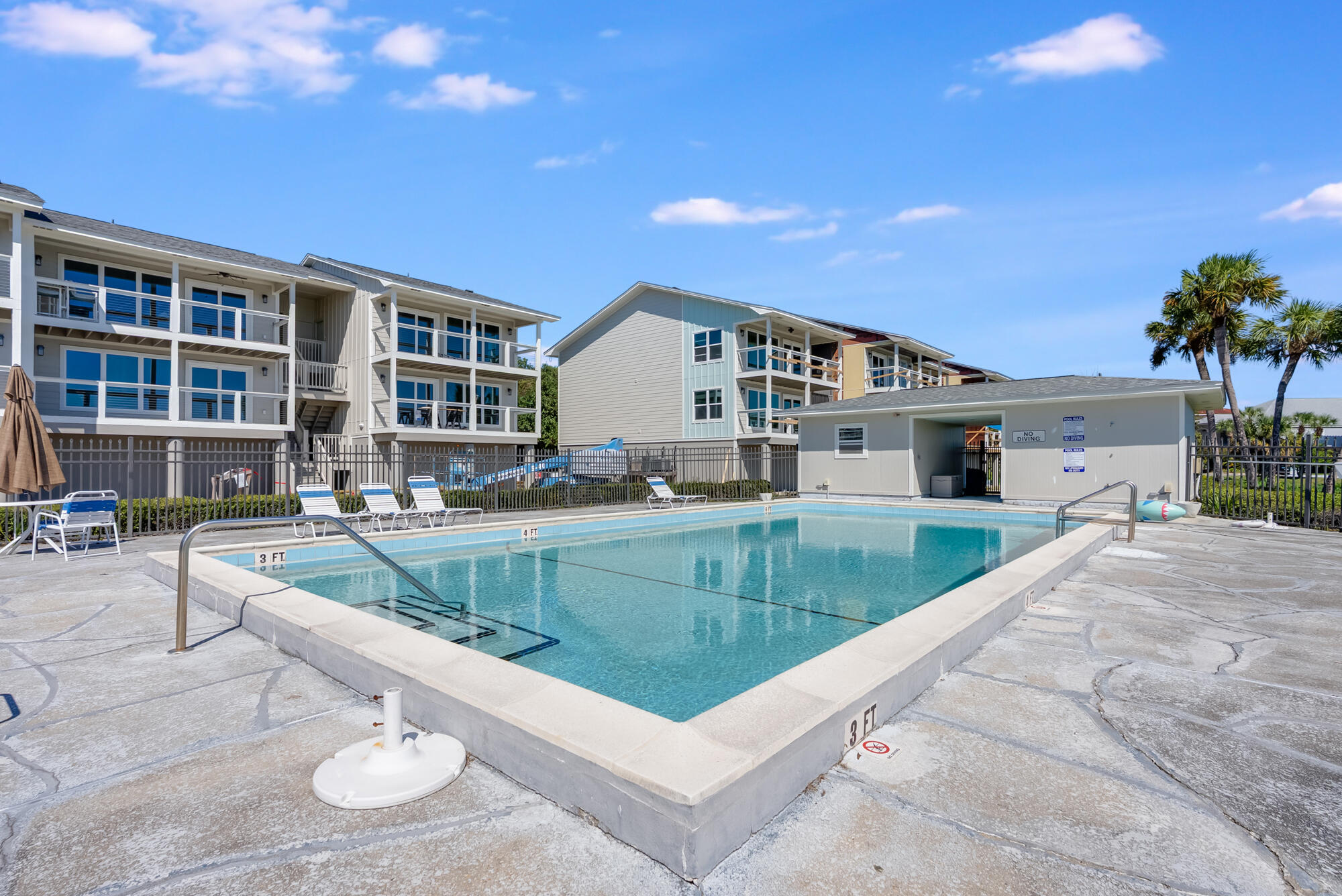 200 Pensacola Beach Road, Unit D2 Gulf Breeze, FL 32561 - Photo 30 of 38 a view of a house with pool and chairs