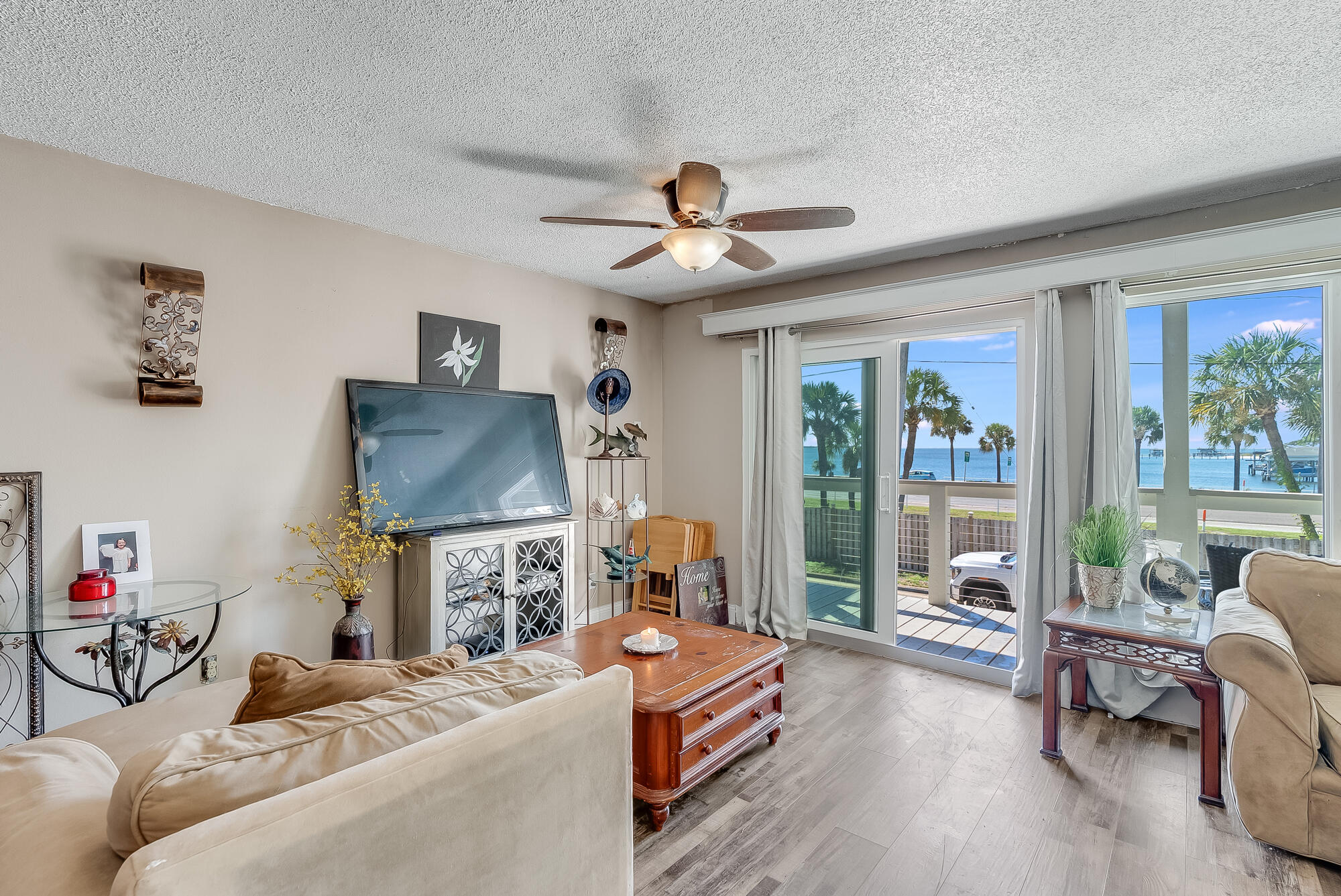 200 Pensacola Beach Road, Unit D2 Gulf Breeze, FL 32561 - Photo 6 of 38 a living room with furniture a flat screen tv and a large window