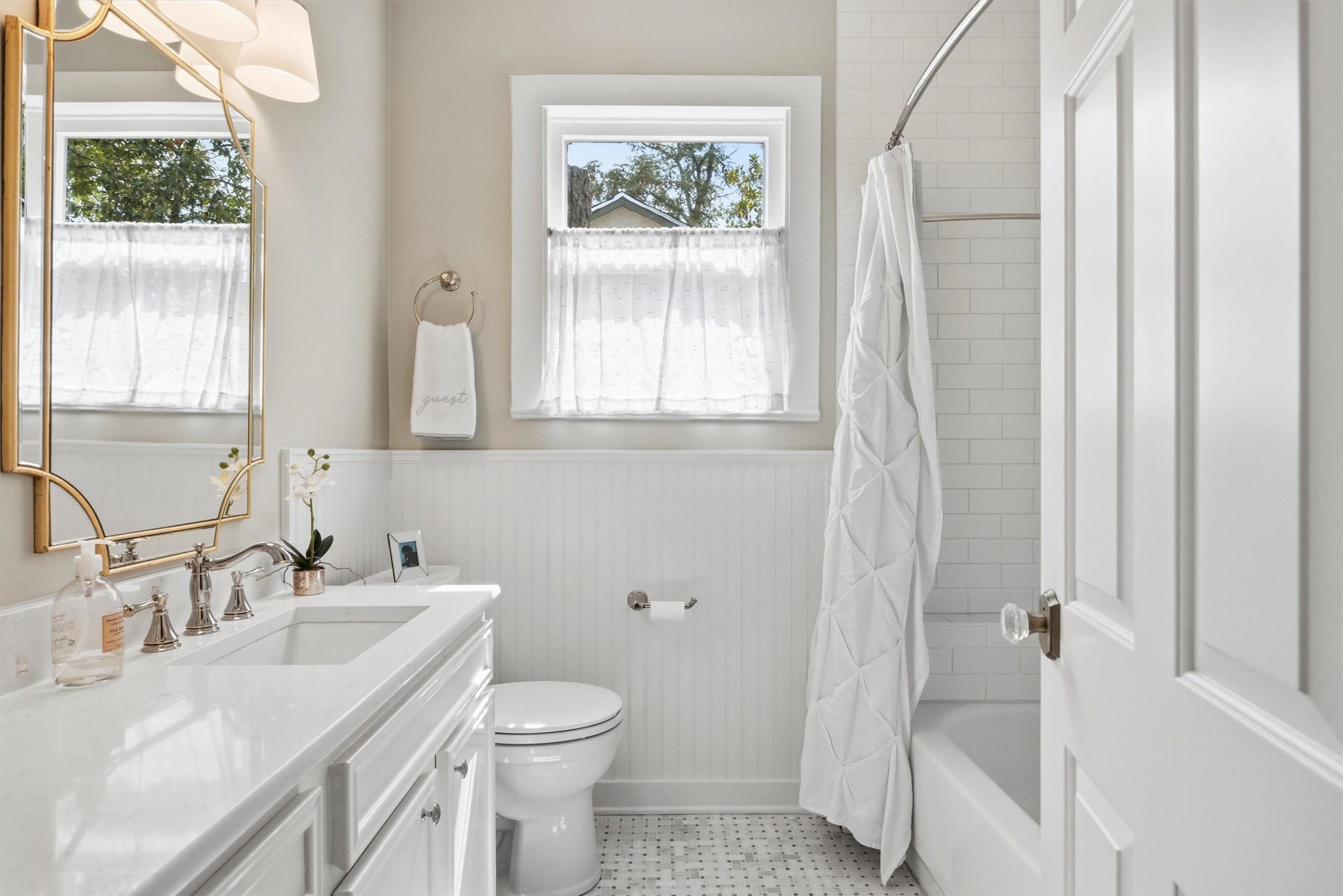 1507 Wethersfield Road Austin, TX 78703 - Photo 31 of 40 a bathroom with a sink a toilet and a large mirror