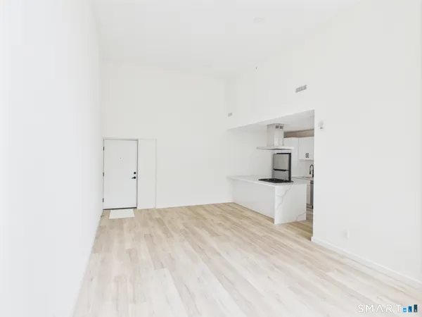 a view of a bedroom with a bed and cabinets