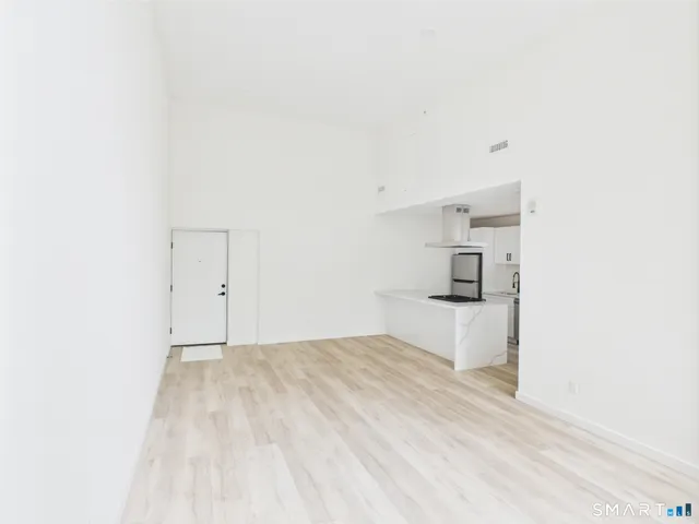 a view of a bedroom with a bed and cabinets