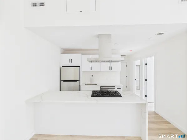 a kitchen with cabinets and white appliances