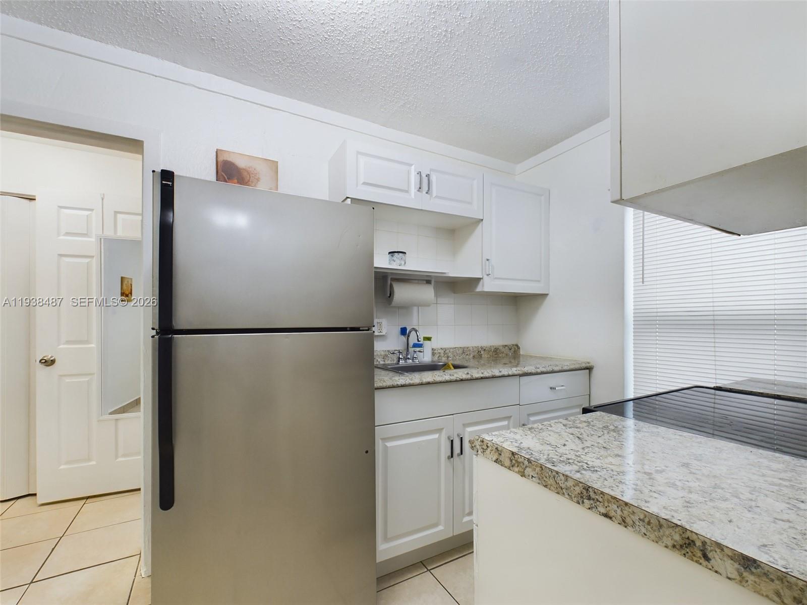 616 Southwest 8th Street, Unit 620 Homestead, FL 33030 - Photo 8 of 11 a kitchen with stainless steel appliances granite countertop a refrigerator and a sink