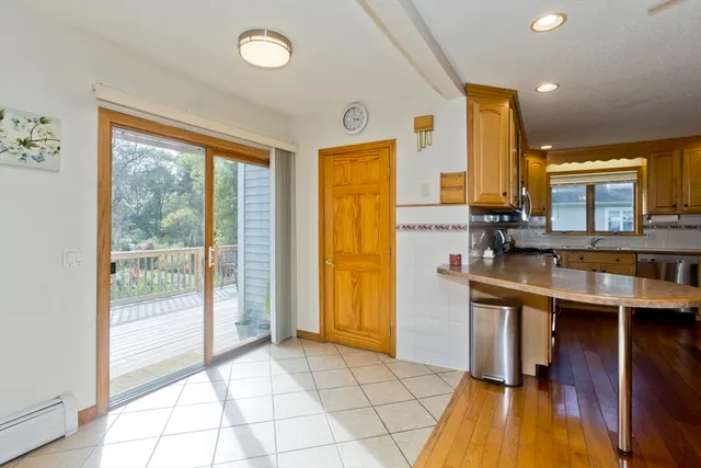 a view of a kitchen with furniture and wooden floor
