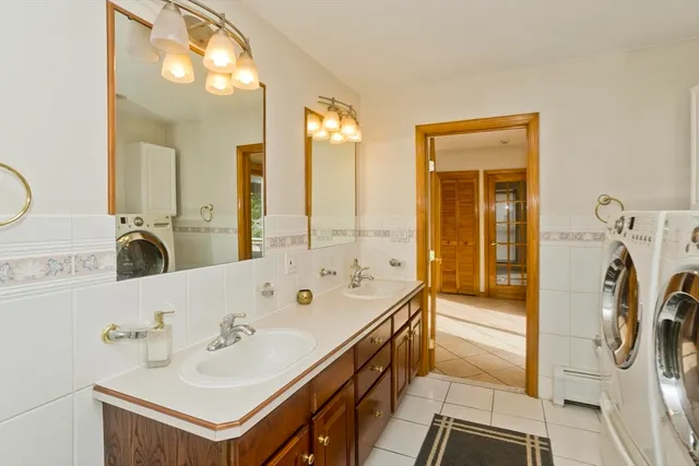 a bathroom with a bathtub a sink a mirror and shower