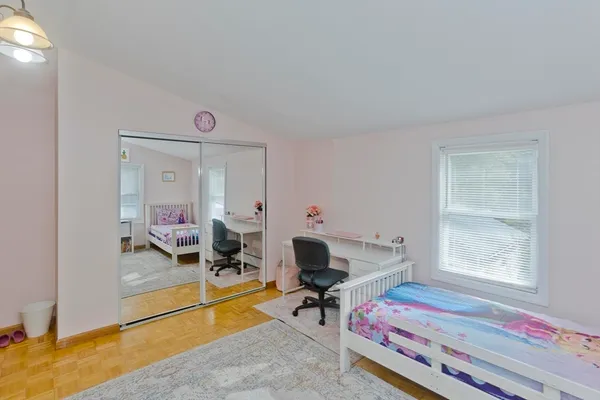 a bedroom with furniture and a window