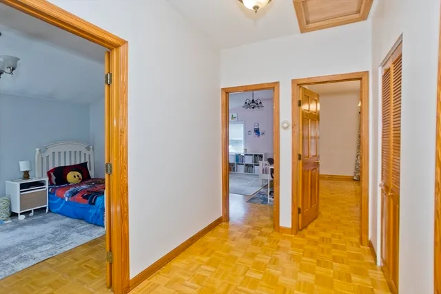 a view of a hallway with wooden shelves