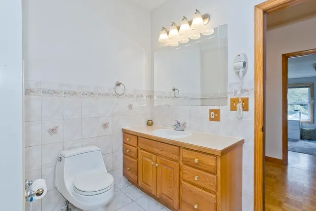 a spacious bathroom with a sink a toilet and a mirror
