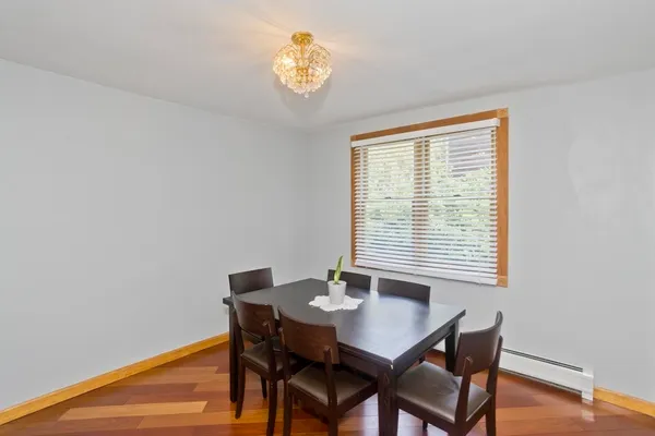 a view of a dining room with a table and chairs