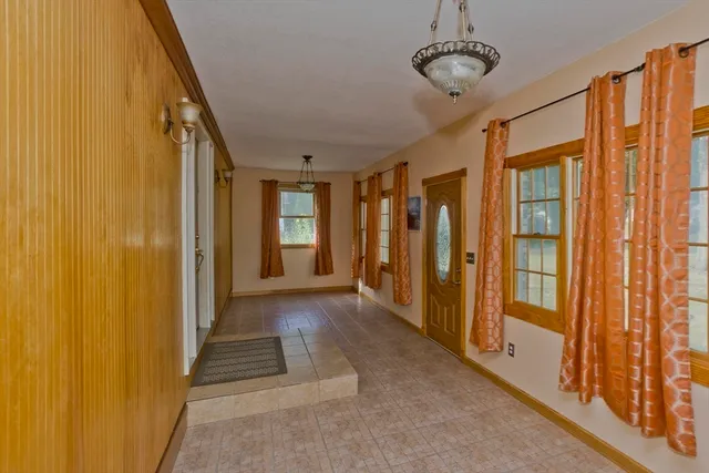 a view of a hallway with wooden shelves