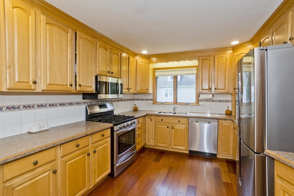 65 Verdugo Street West Springfield, MA 01089 - Photo 7 of 40 a kitchen with stainless steel appliances granite countertop a stove a sink and a refrigerator