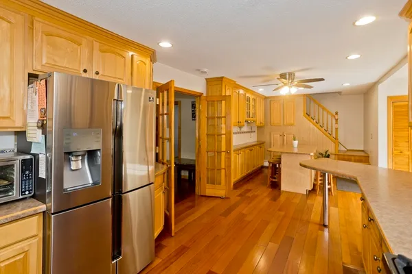 a very nice looking room with a large window and stainless steel appliances