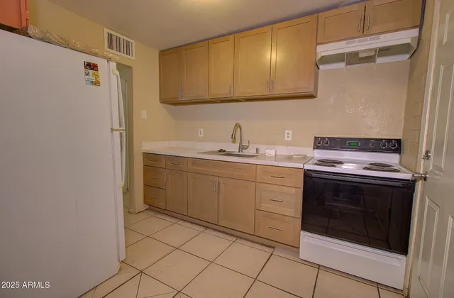a view of an empty room with window and closet