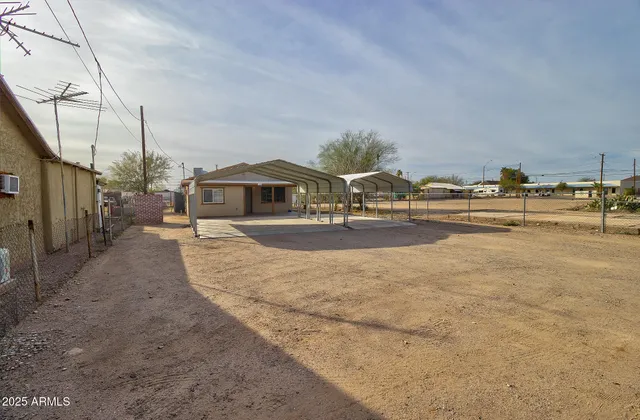 a view of a house with a yard and sitting area