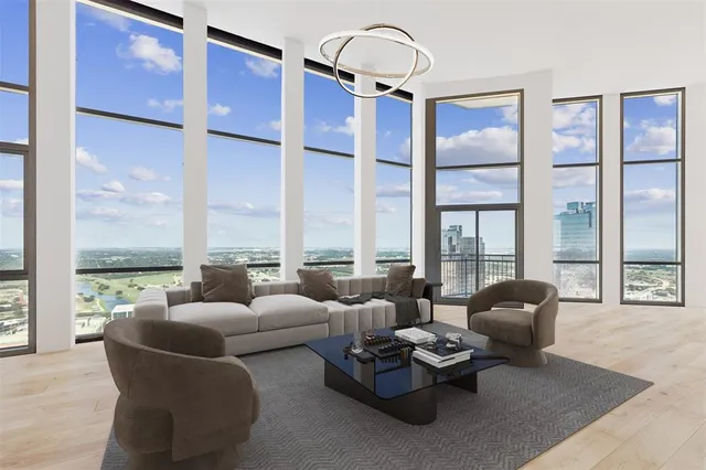 a living room with furniture and floor to ceiling windows