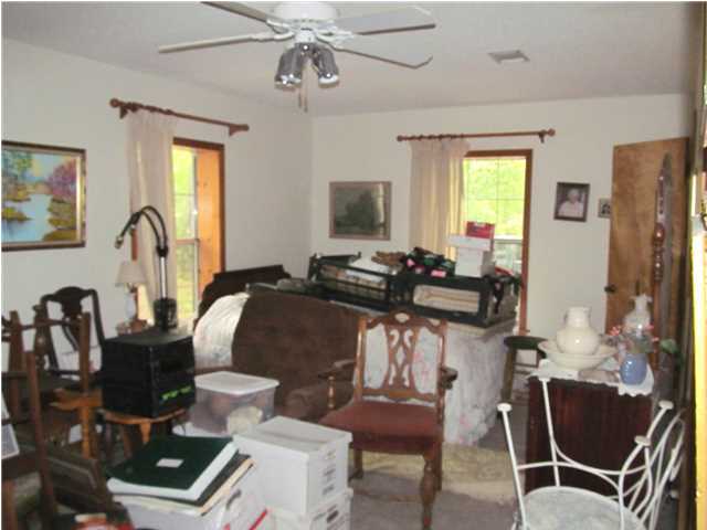 436 Thornton Road DeFuniak Springs, FL 32435 - Photo 11 of 13 a living room with furniture a flat screen tv and a window