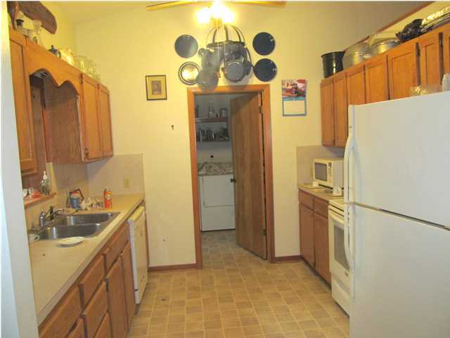 436 Thornton Road DeFuniak Springs, FL 32435 - Photo 7 of 13 a kitchen with a refrigerator and a sink