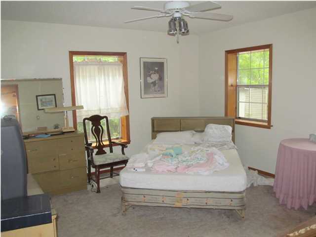 436 Thornton Road DeFuniak Springs, FL 32435 - Photo 10 of 13 a bedroom with a bed a table and chair