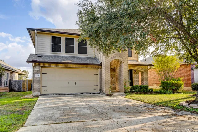 a front view of house with yard and trees
