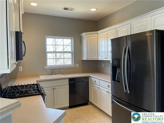 a kitchen with a sink stove and refrigerator