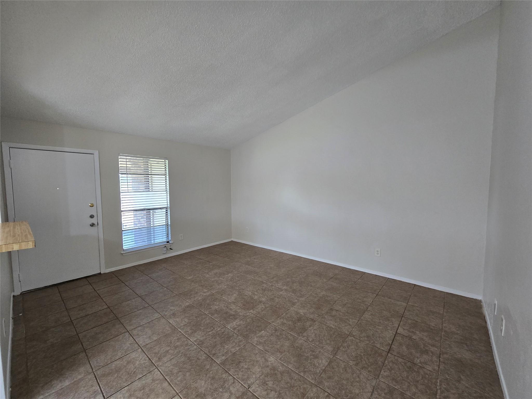 6206 Buffalo Pass, Unit A Austin, TX 78745 - Photo 10 of 24 A spacious living area featuring durable tile flooring and abundant natural light from a well-placed window.
