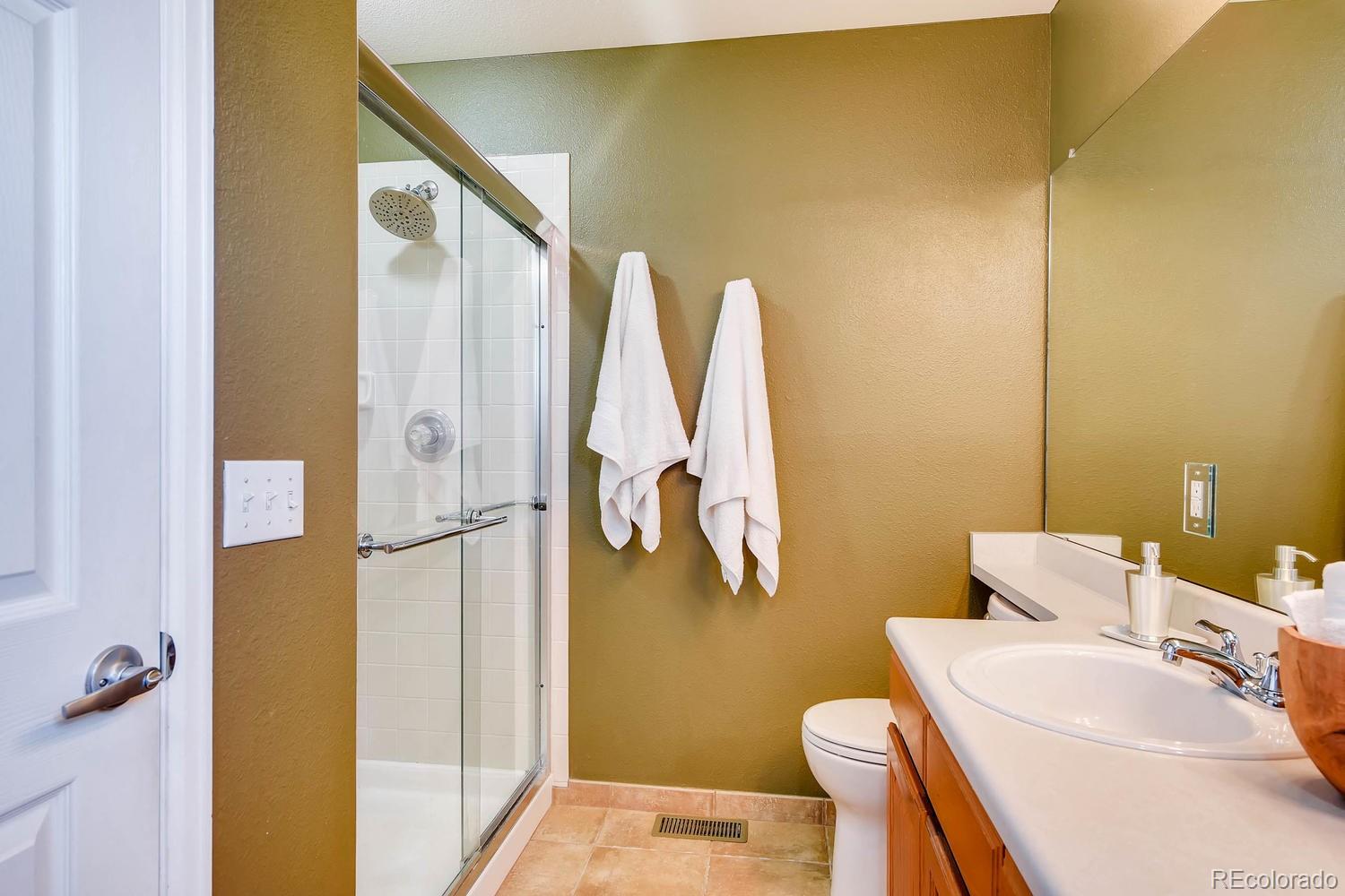9825 South Thornbury Way Highlands Ranch, CO 80129 - Photo 15 of 27 a bathroom with a sink and a mirror