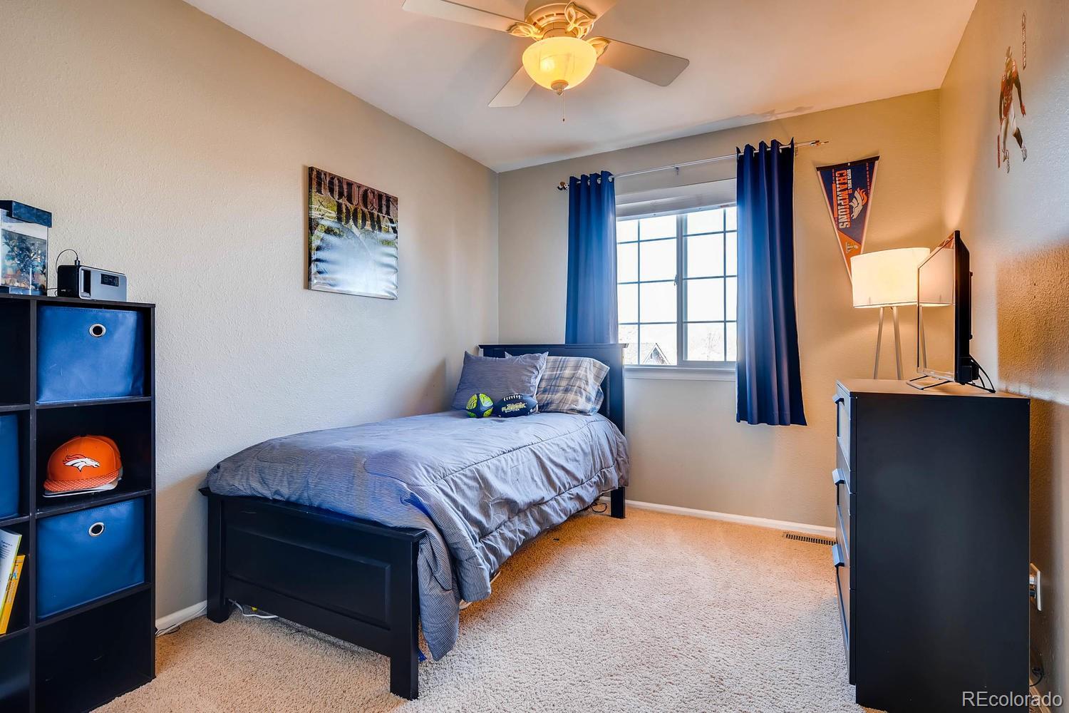 9825 South Thornbury Way Highlands Ranch, CO 80129 - Photo 17 of 27 a bedroom with a bed and a fireplace
