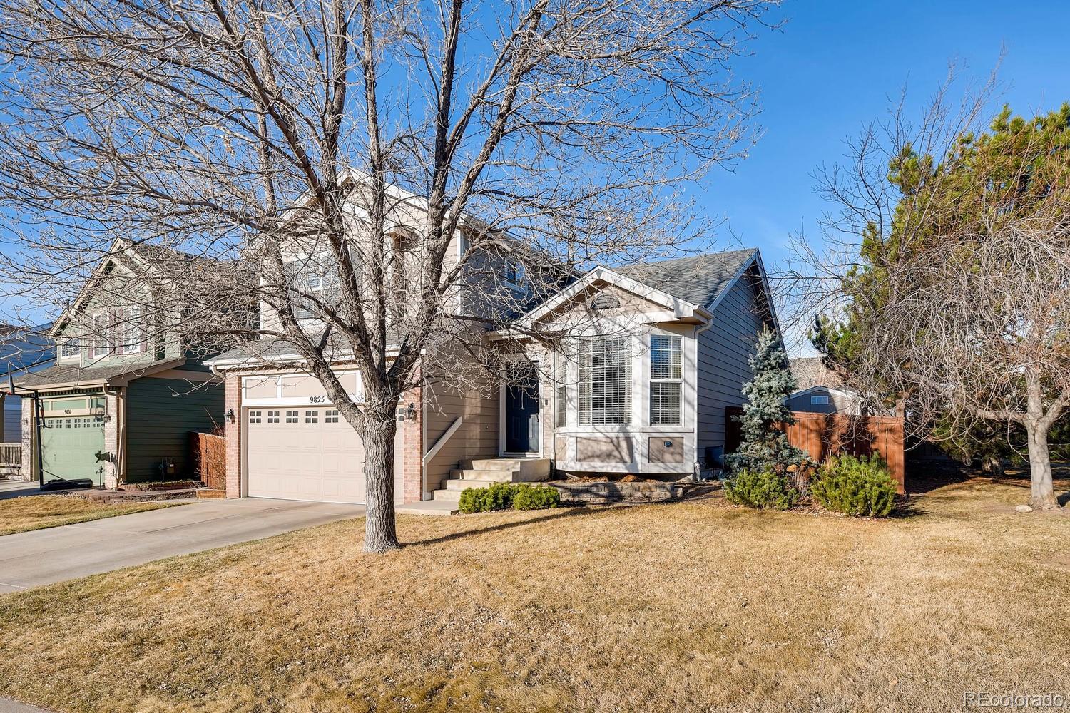 9825 South Thornbury Way Highlands Ranch, CO 80129 - Photo 2 of 27 a front view of a house with a yard
