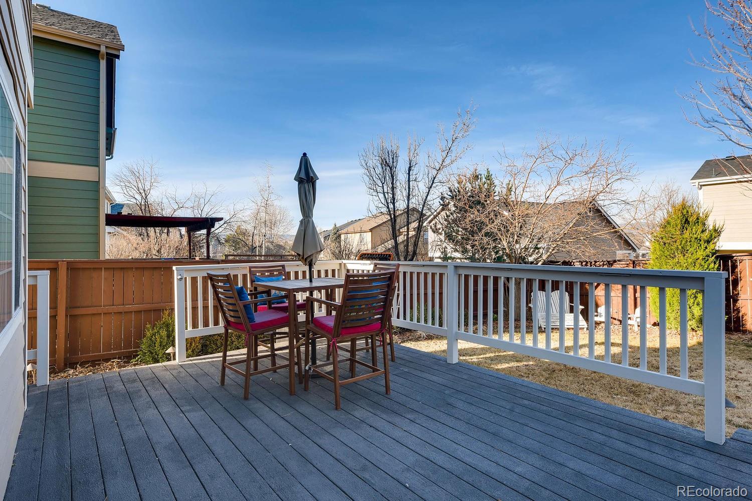 9825 South Thornbury Way Highlands Ranch, CO 80129 - Photo 22 of 27 a view of a chairs and table on the wooden floor