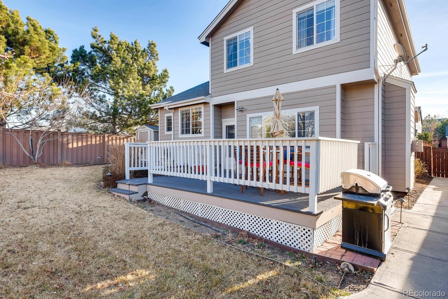 9825 South Thornbury Way Highlands Ranch, CO 80129 - Photo 24 of 27 a view of a house with a yard and deck