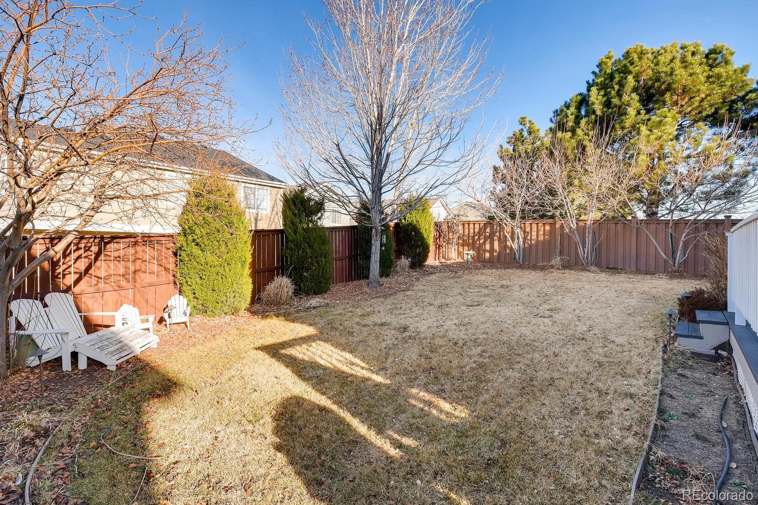 9825 South Thornbury Way Highlands Ranch, CO 80129 - Photo 26 of 27 a view of a yard covered with snow in front of house