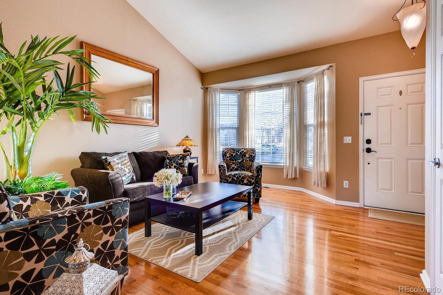 9825 South Thornbury Way Highlands Ranch, CO 80129 - Photo 5 of 27 a living room with furniture and a large window