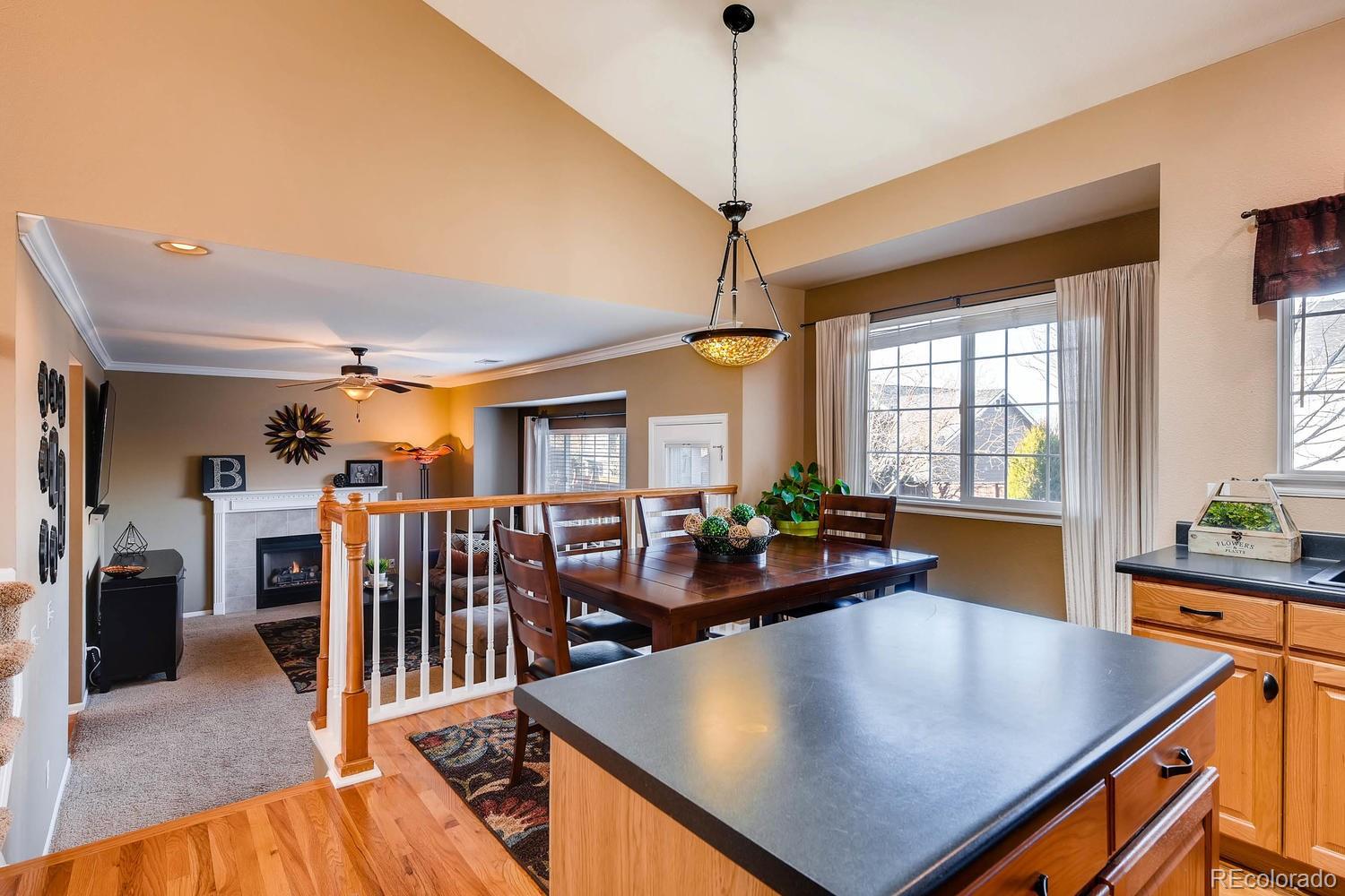 9825 South Thornbury Way Highlands Ranch, CO 80129 - Photo 9 of 27 a view of a dining room with furniture window and wooden floor