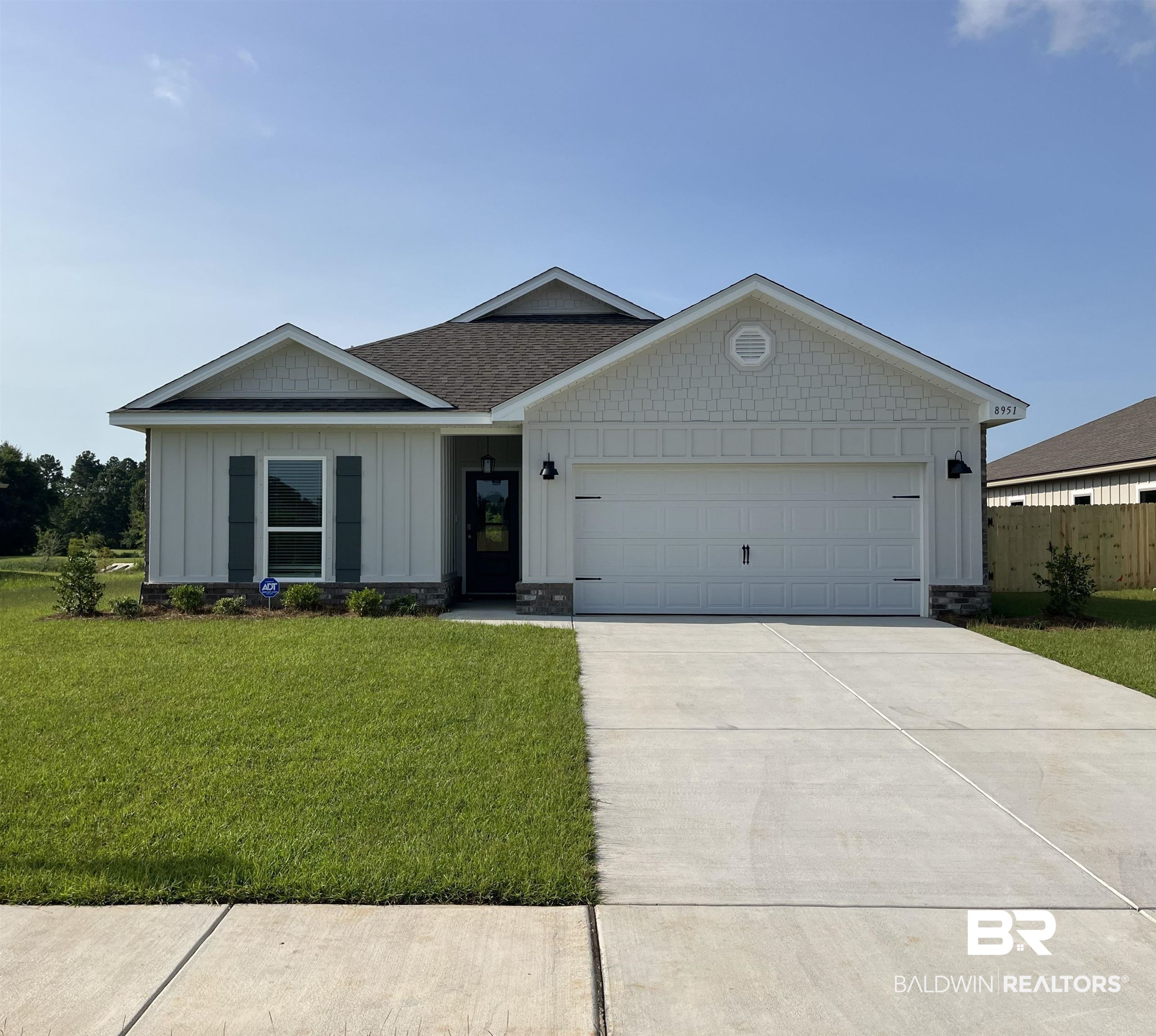 8951 Chabo Circle Foley, AL 36535 - Photo 1 of 39 Contemporary single-story residence featuring light-colored vertical siding and a dark shingle roof