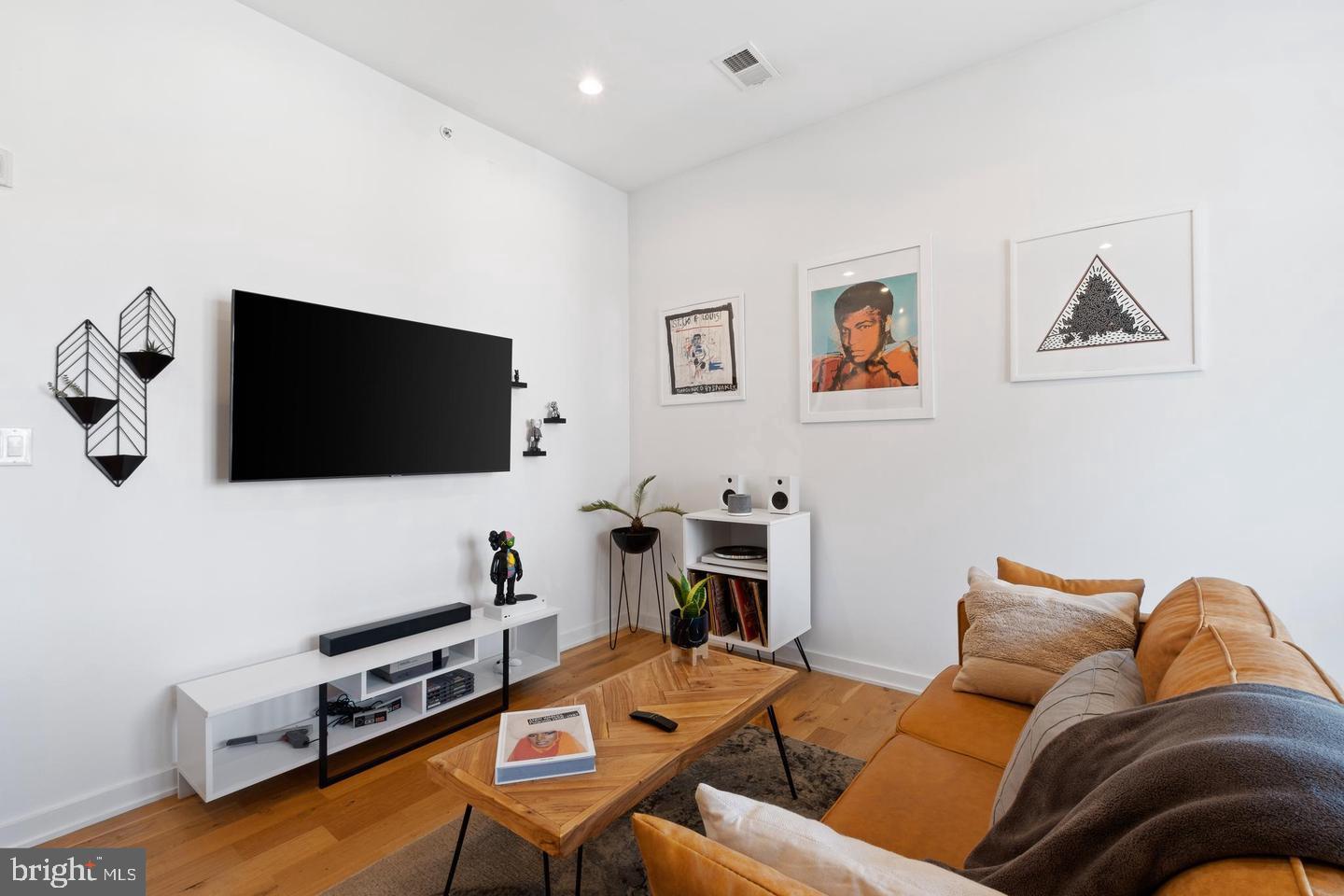 1617-27 Hope Street, Unit 2D Philadelphia, PA 19122 - Photo 14 of 32 a living room with furniture and a flat screen tv