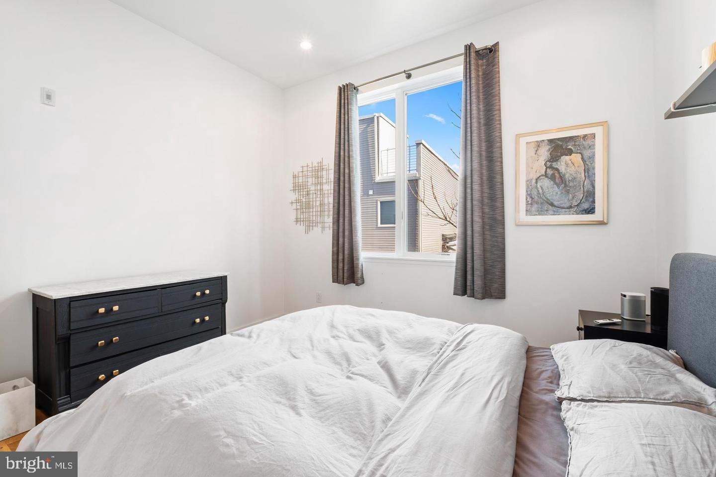 1617-27 Hope Street, Unit 2D Philadelphia, PA 19122 - Photo 22 of 32 a bedroom with a bed and a painting on the wall