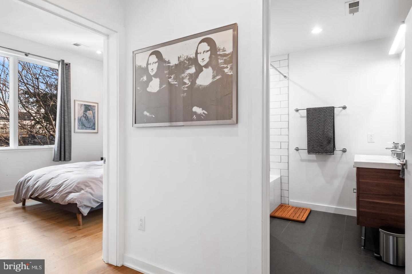 1617-27 Hope Street, Unit 2D Philadelphia, PA 19122 - Photo 24 of 32 a bedroom with a bed and a television