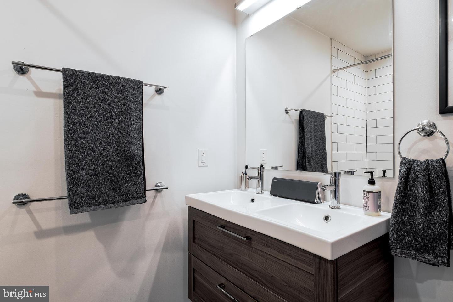 1617-27 Hope Street, Unit 2D Philadelphia, PA 19122 - Photo 29 of 32 a bathroom with a sink and a mirror