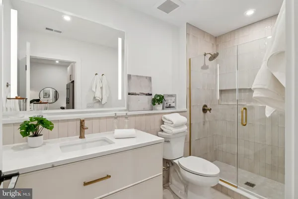 a bathroom with a sink toilet and shower