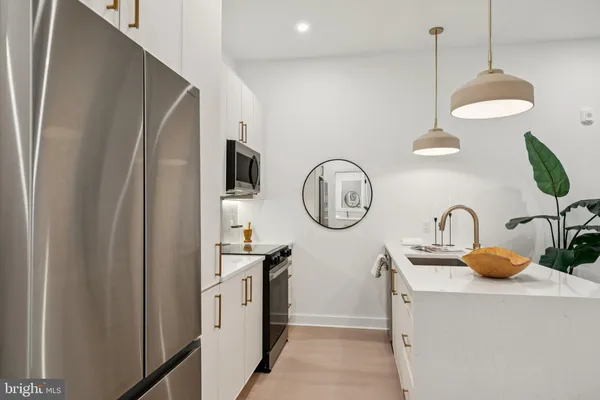 a kitchen with a refrigerator and a sink