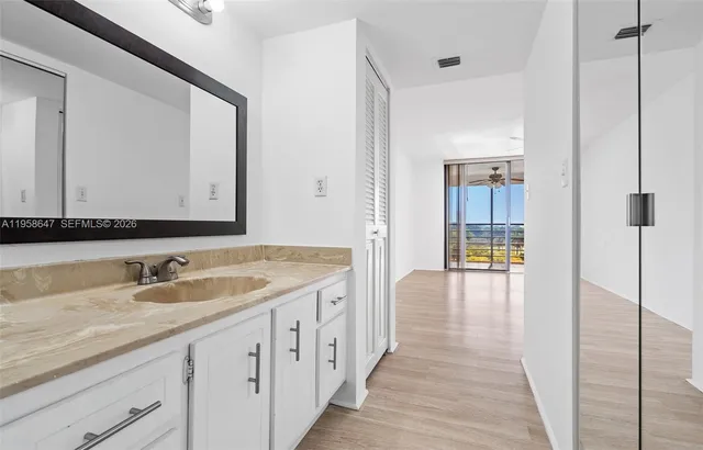 a spacious bathroom with a sink and a mirror