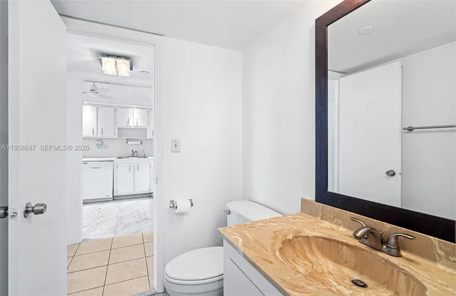 a bathroom with a sink toilet vanity and tub