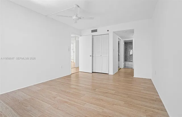 a view of an empty room with wooden floor