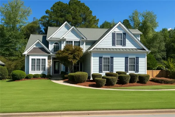 a front view of house with yard and green space