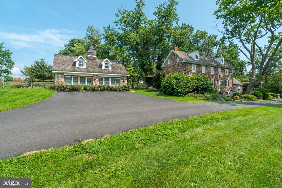 1515 Sugar Bottom Road Furlong, PA 18925 - Photo 80 of 96 a front view of a house with a garden and yard